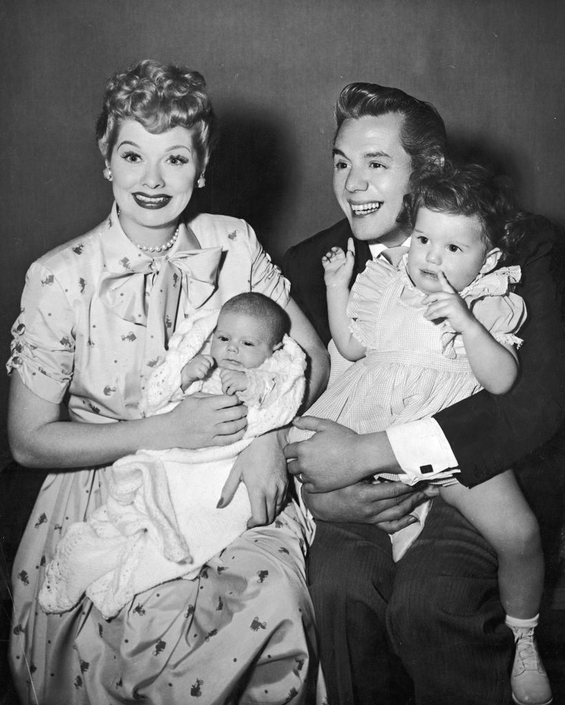 American actors and comedian Lucille Ball (1911 - 1989) and her husband, Cuban-born actor and bandleader Desi Arnaz (1917 - 1986), laugh and smile while holding their two children, Desi Jr (left) and Lucie, 1953
