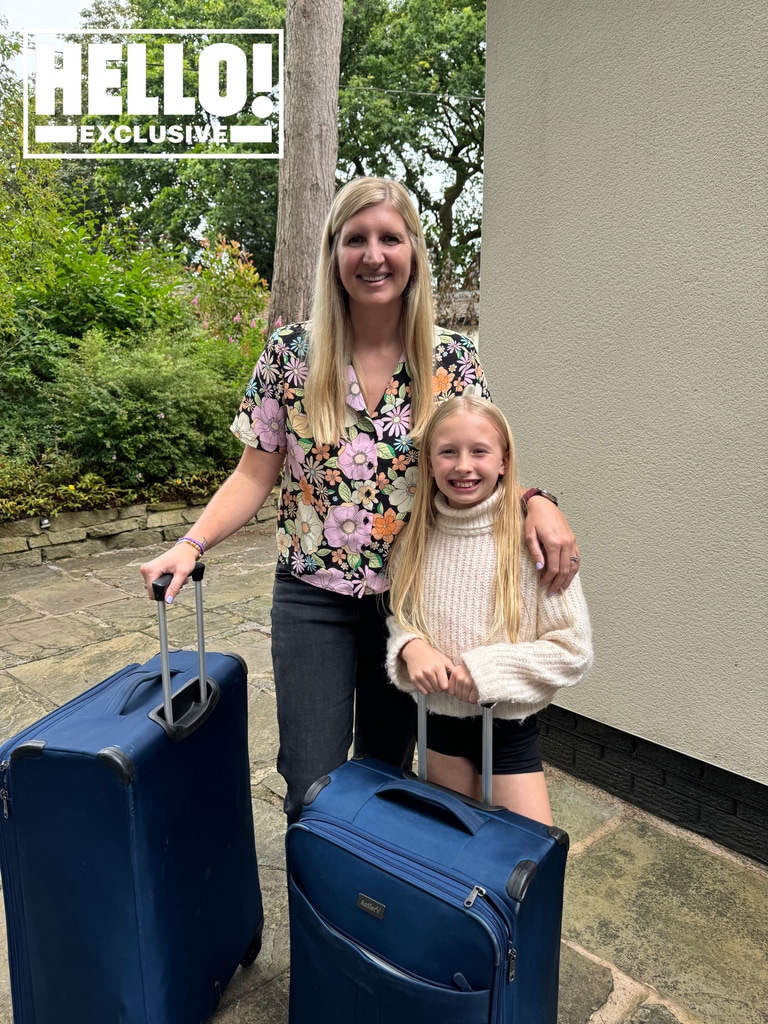 Rebecca's daughter, Summer, standing with her mum and their suitcases