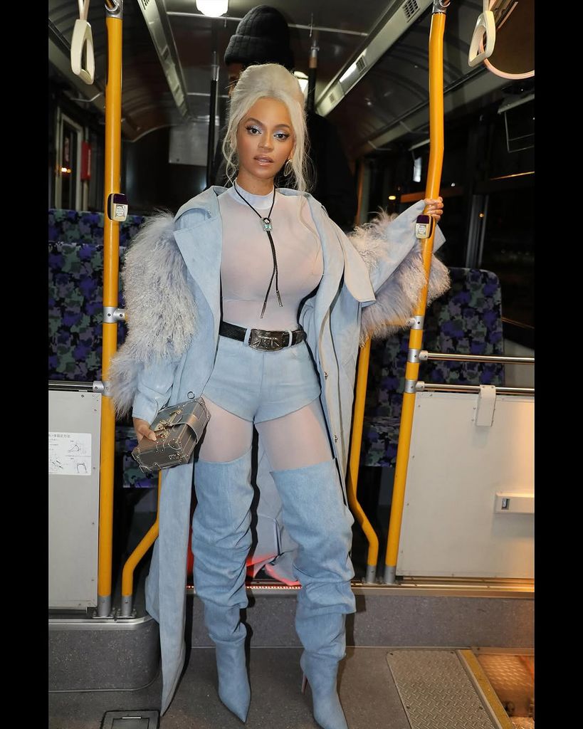 Beyonce standing on a bus while traveling through Tokyo