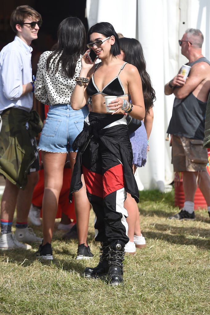  Dua Lipa seen at Glastonbury Festival 2019 wearing a velvet bra, red and black torusers and chunky boots