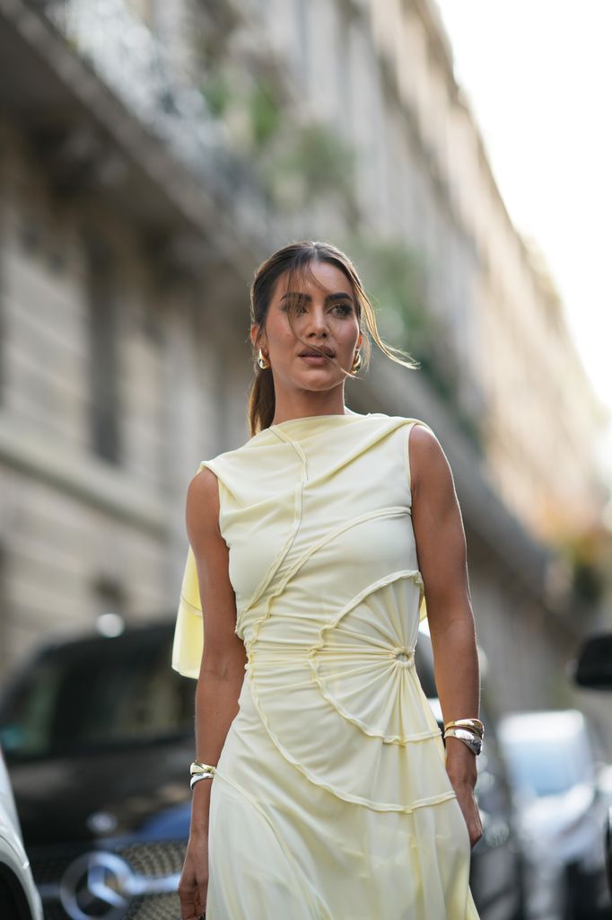 Camila Coelho wears a sleeveless pastel pale gathered long flowing dress,  outside Victoria Beckham, during the Womenswear Spring/Summer 2024 as part of  Paris Fashion Week on September 29, 2023 in Paris, France. 