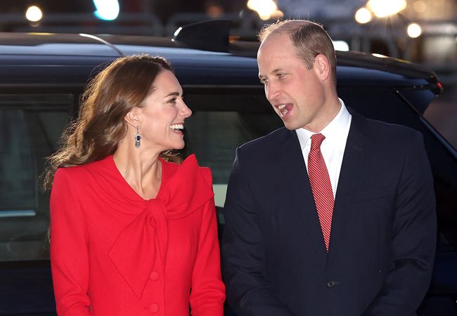 Prince willliam and kate middleton looking at each other and laughing