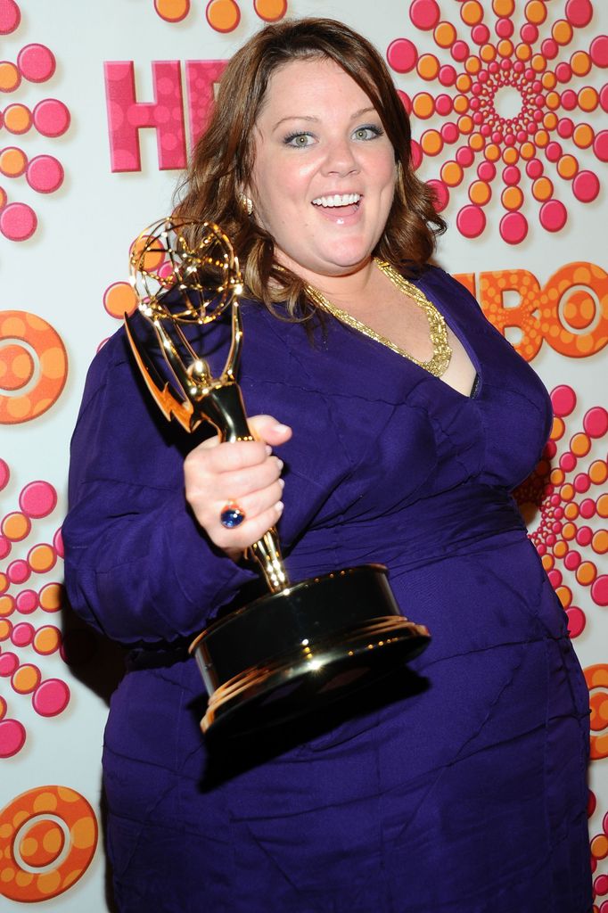 Melissa holding an Emmy in 2011