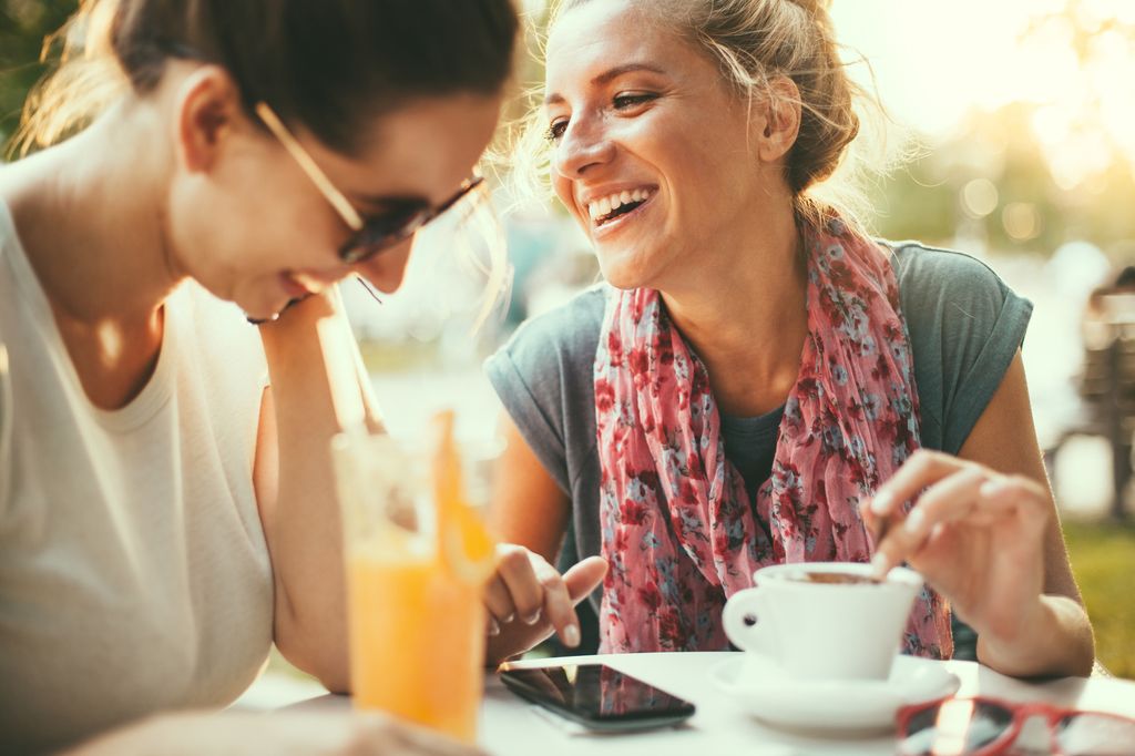 Female friends talking in cafe