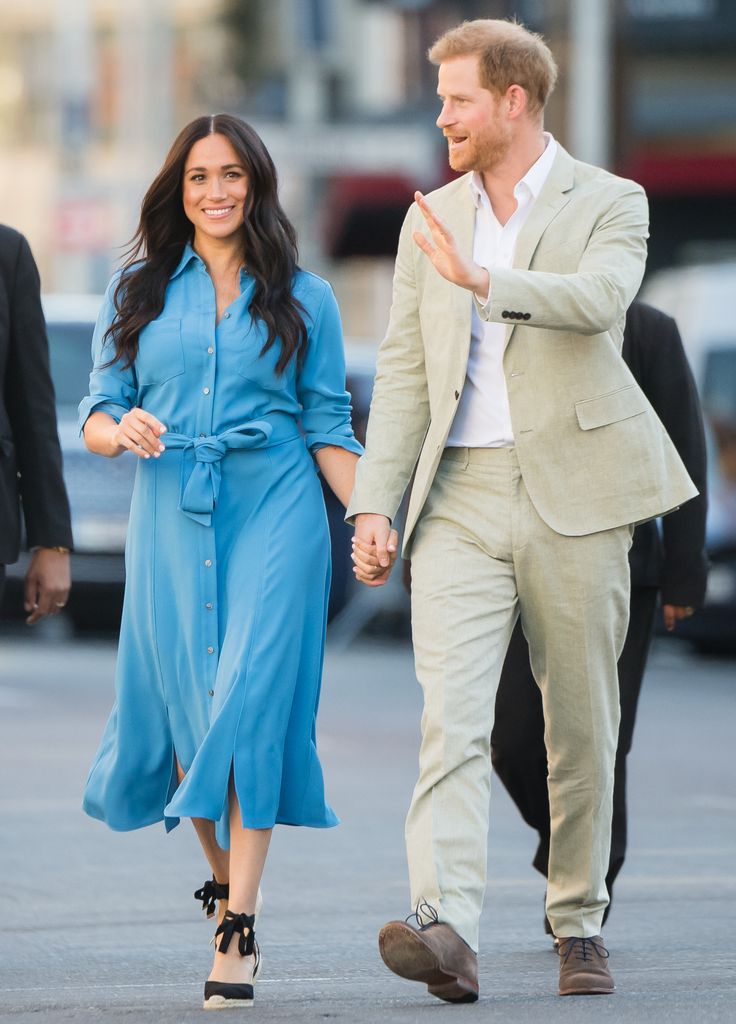 Meghan, Duchess of Sussex in blue shirt dress with harry