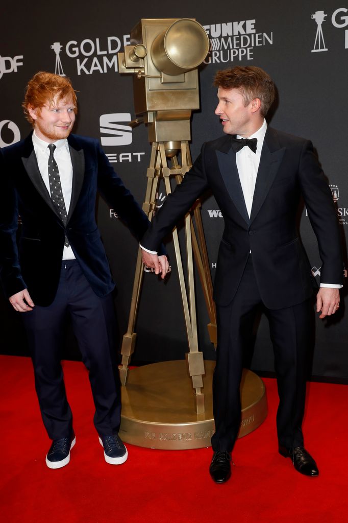 A photo of Ed Sheeran and James Blunt holding hands