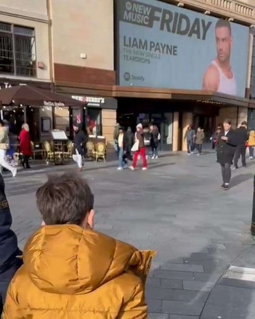 Liam Payne's son Bear looking at a billboard of his dad