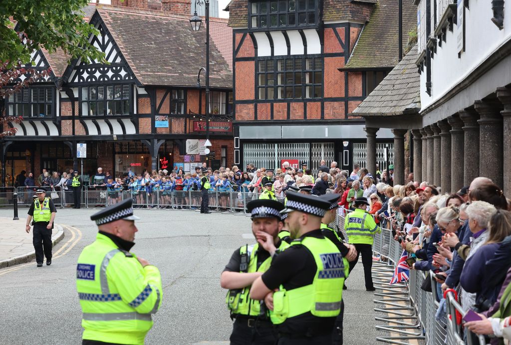 A general view of aolice and well-wishers as they line the street ahead of the wedding of The Duke of Westminster and Miss Olivia Henson at Chester Cathedral