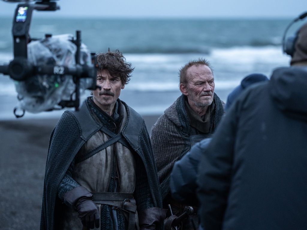A behind-the-scenes picture of two men on a beach
