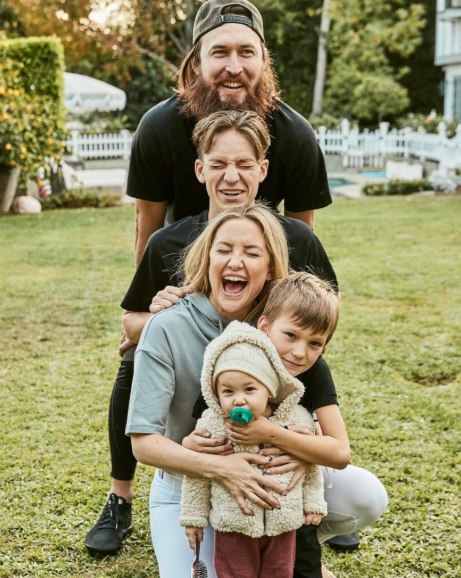 Kate Hudson with children and husband in a line laughing