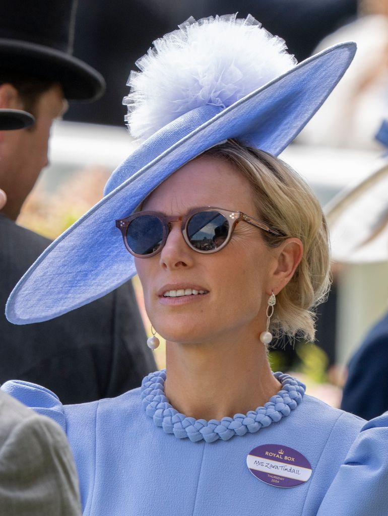 Zara Tindall wearing blue hat and sunglases