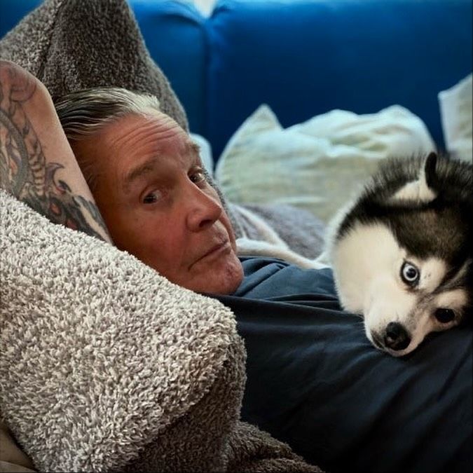 Ozzy Osbourne lies on a couch with his dog Elvis, captured in a photo shared on Instagram