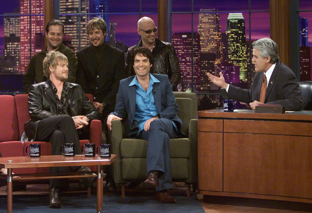 Rob Hotchkiss, Charlie Colin, Scott Underwood, Patrick Monahan, and Jimmy Stafford of rock band Train during an interview with host Jay Leno on February 28, 2002 
