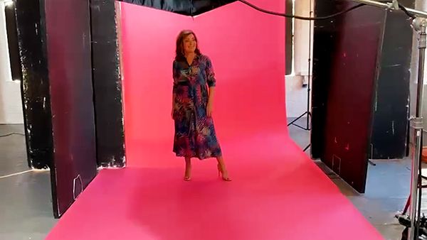 Lorraine Kelly poses at a photoshoot in a flowing dress