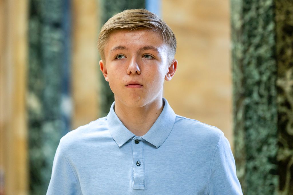 lose-up of young blonde child in blue shirt