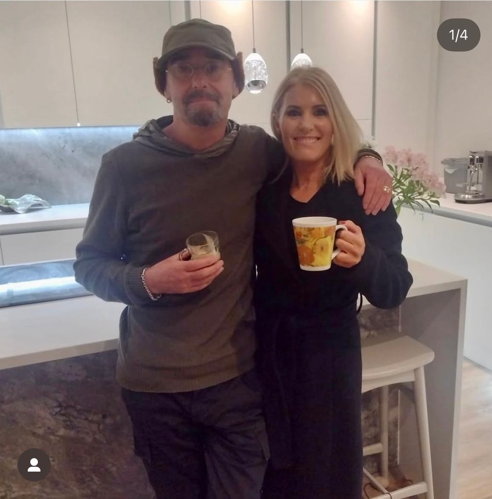 Bonehead of Oasis posing for photo with fan in kitchen