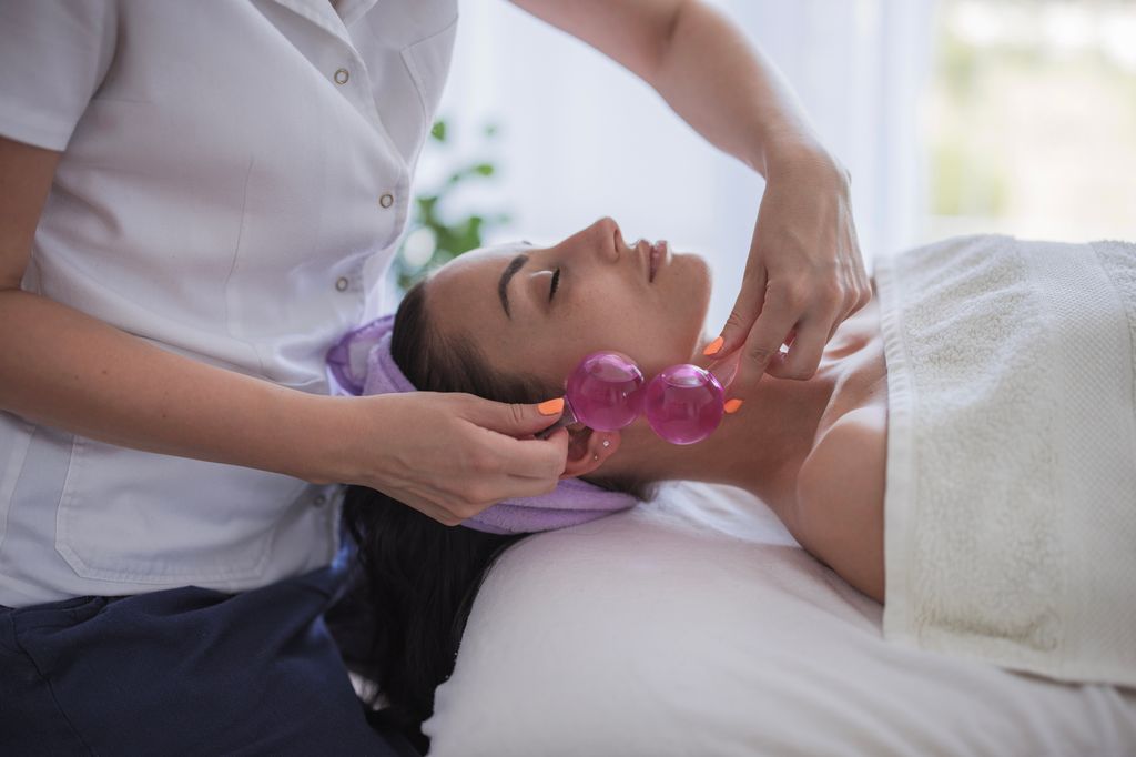 Close-up of a woman undergoing cryo globe facial massage