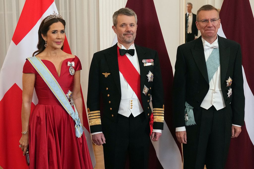 Denmark's King Frederik and Queen Mary pose as they arrive for the State dinner hosted by Latvia's President Edgars Rinkevics (R) 