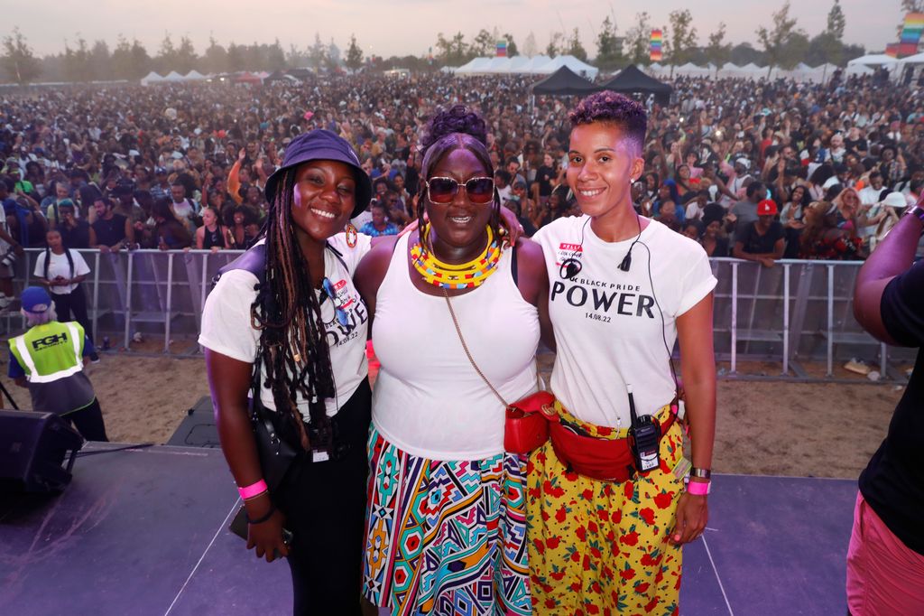 Lady Phyll Opoku-Gyimah and two women in front of a crowd of people