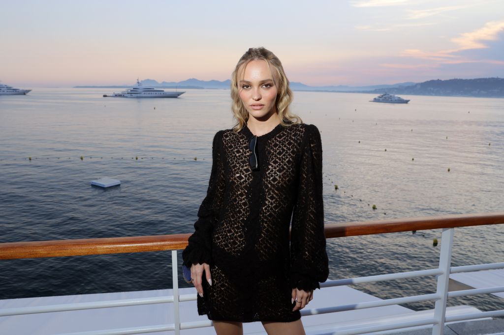 Lily Rose Depp in front of the sea at sunset