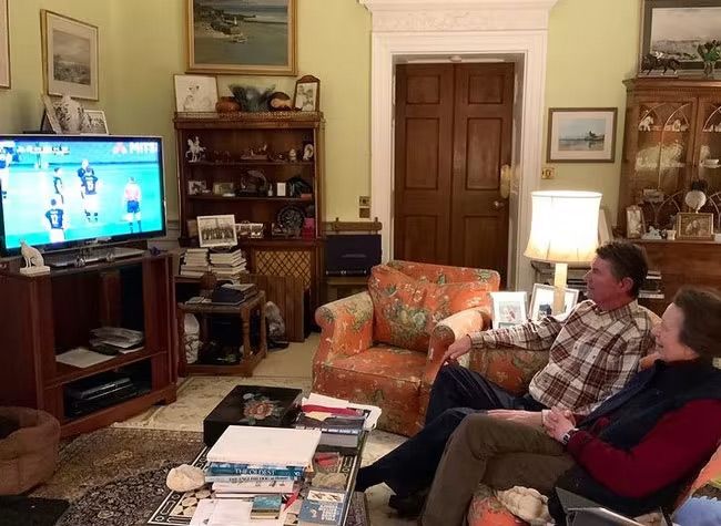 princess anne in living room with husband watching tv