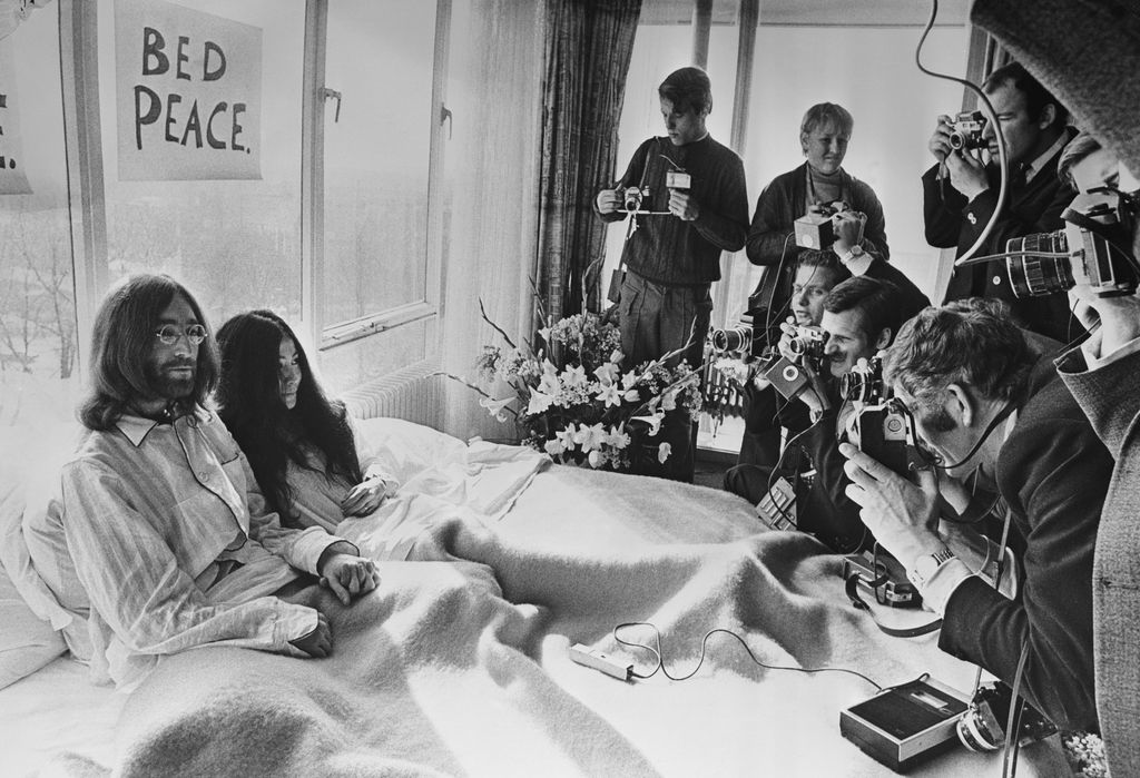 25th March 1969:  A week after their marriage, musicians John Lennon and Yoko Ono receive the press at their bedside in the Presidential Suite of the Hilton Hotel, Amsterdam. The couple stayed in bed for seven days 'as a protest against war and violence in the world'.  (Photo by Central Press/Getty Images)