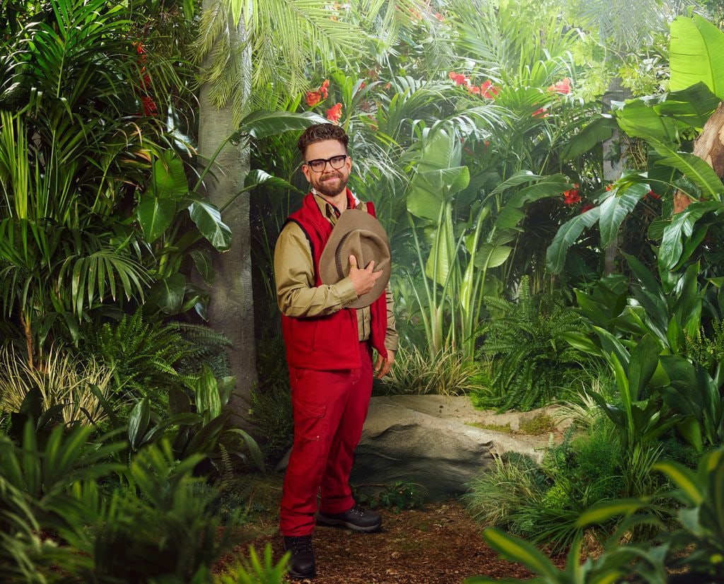 person in red and beige uniform in jungle setting