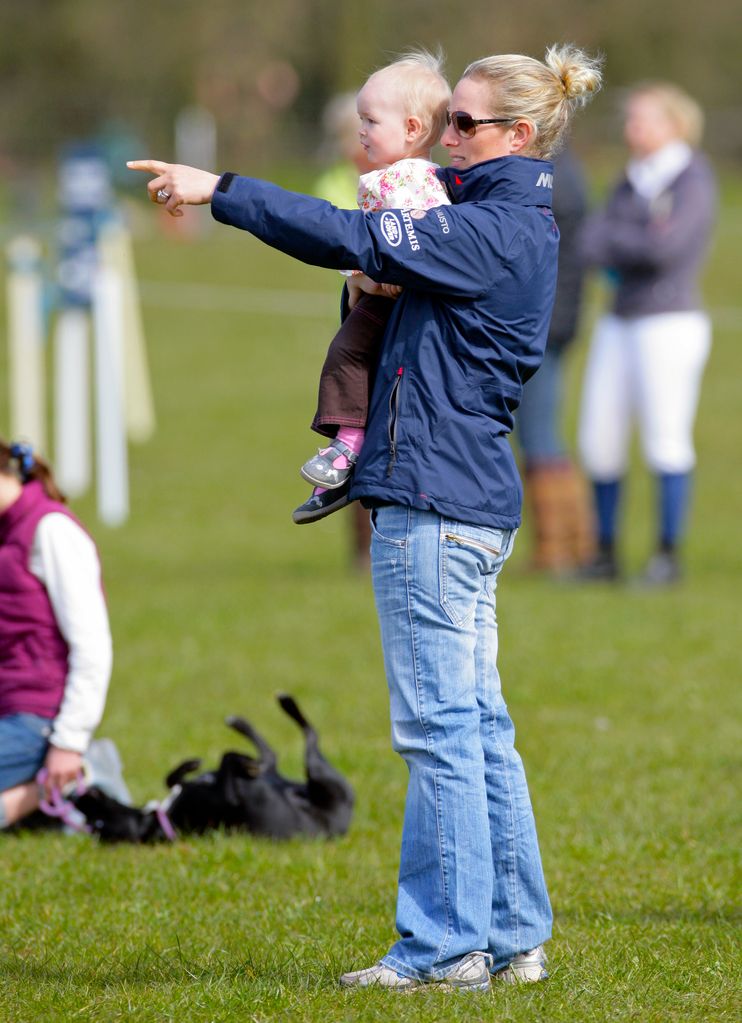 Zara Phillips carries her niece Savannah Phillips as they watch the showjumping at the Gatcombe Horse Trials at Gatcombe Park, Minchinhampton on March 25, 2012 in Stroud, England