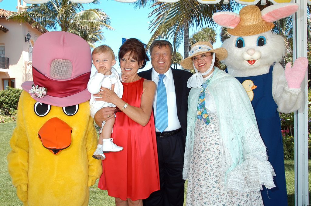 Barron Trump, second from left, is held by grandmother Amalija Knavs who stands next to husband Viktor Knavs