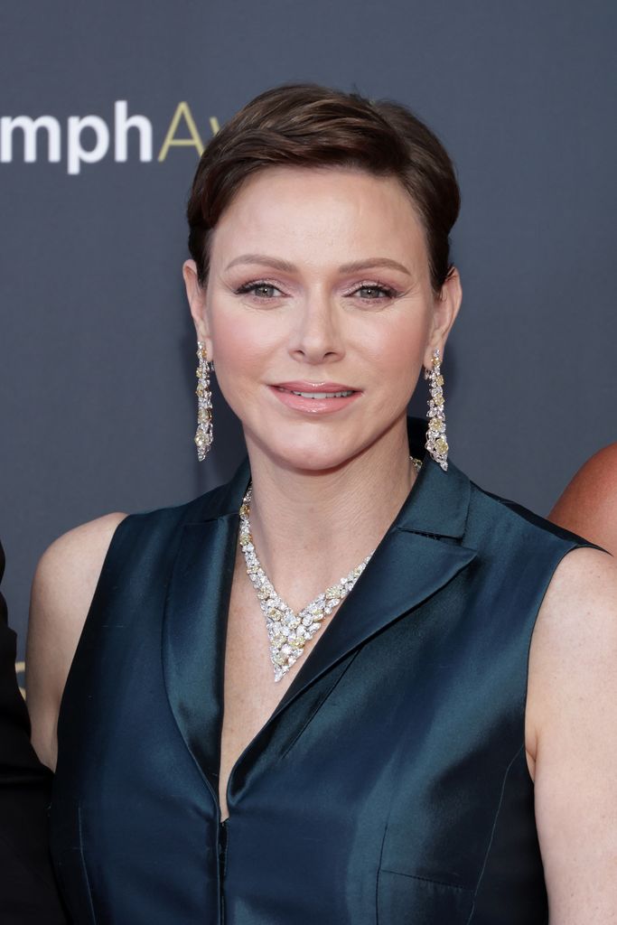 Princess Charlene sported shimmering eye makeup and statement jewellery