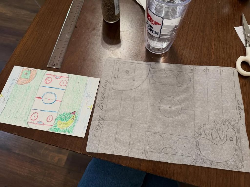 Dylan Dreyer draws out her design for her son Calvin's 9th birthday cake on her dining room table, shared on Instagram