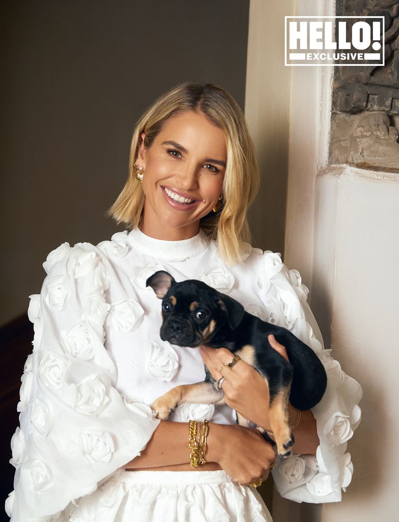 Vogue Williams wears white dress as she carries her dog