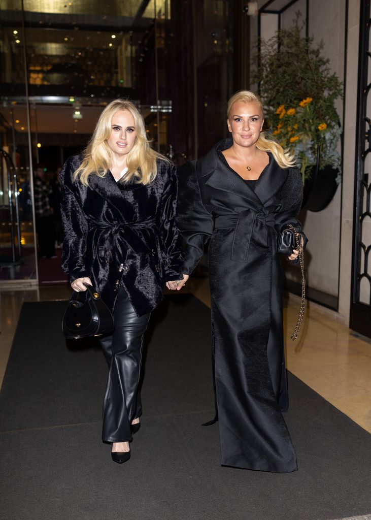 Rebel Wilson and Ramona Agruma walking in all black outfits