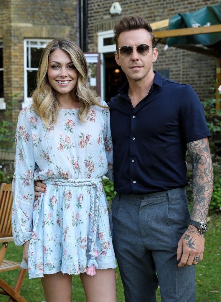 Georgia Jones and Danny Jones smiling outside in a garden