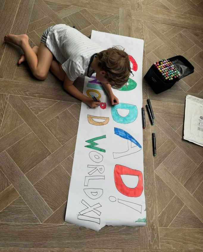 A small child designing a sign