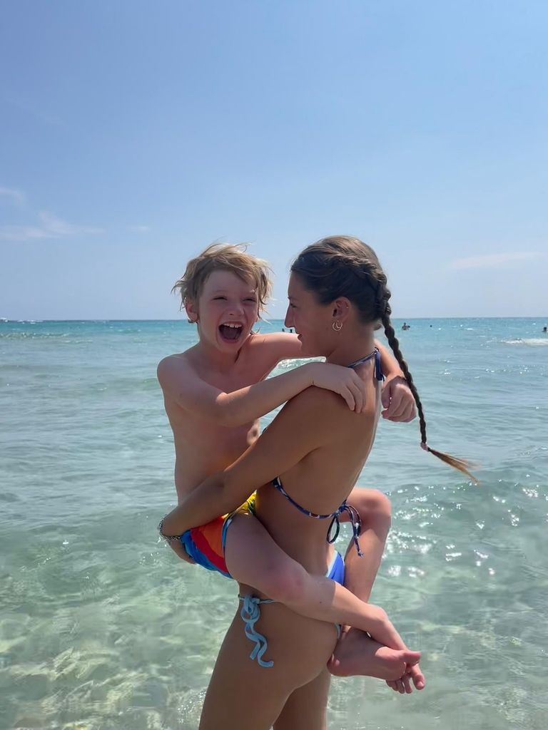 River hugging his sister Petal in sea