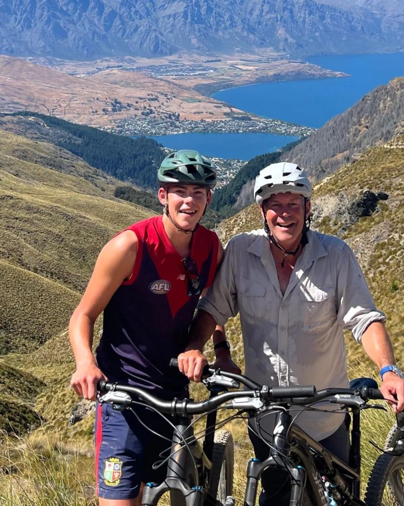 father and son riding on bikes in new zealand 