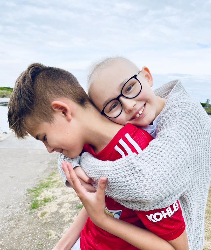 girl hugging brother