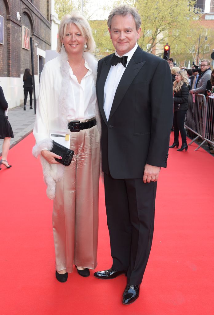 Lulu Williams in silk trousers and Hugh Bonneville in a suit on the red carpet