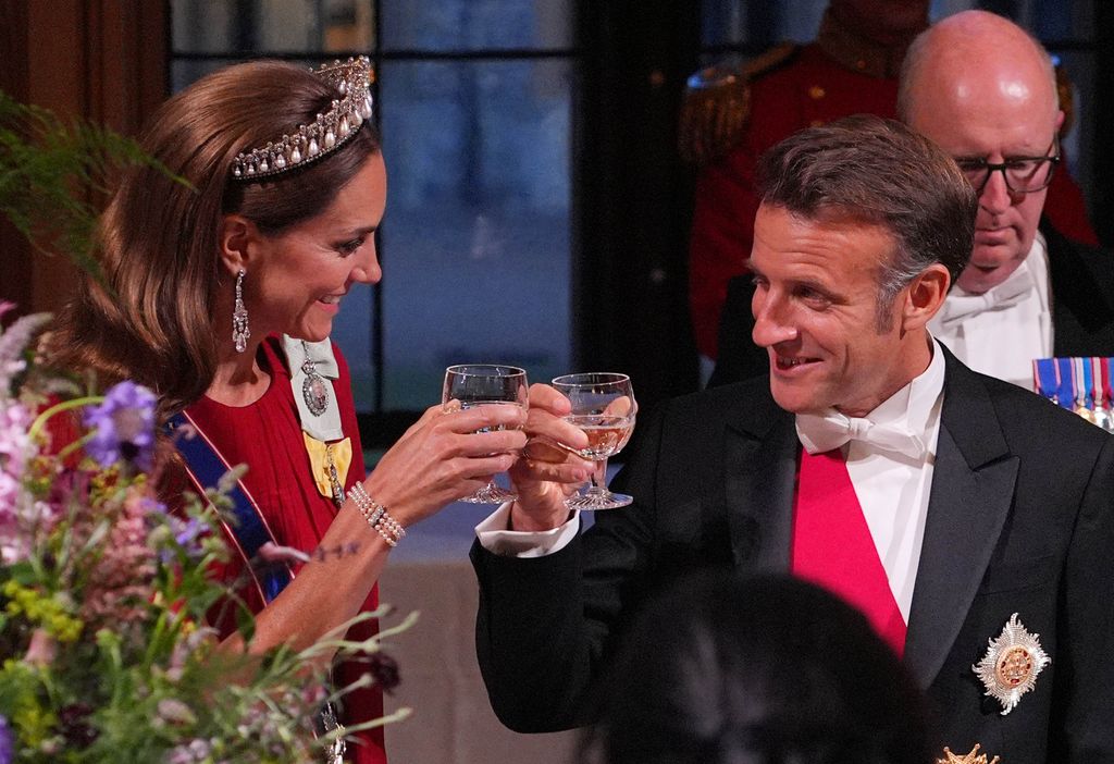  France's President Emmanuel Macron clinks glasses with Catherine, Princess of Wales