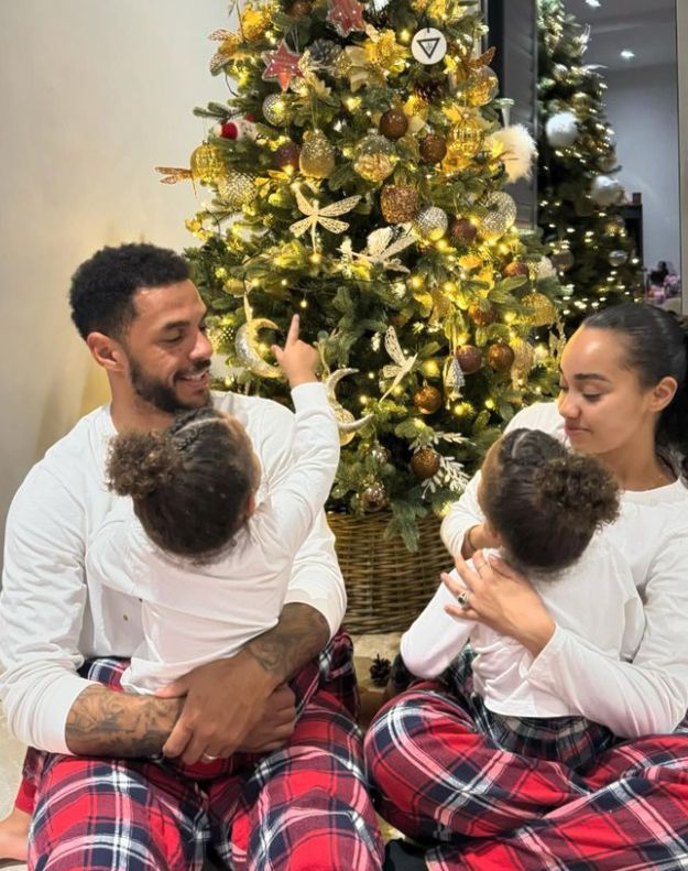 Leigh-Anne Pinnock and Andre Gray holding their children in front of a Christmas tree