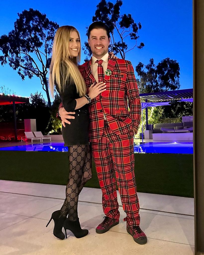 Christina Hall poses with husband Joshua Hall by pool at home
