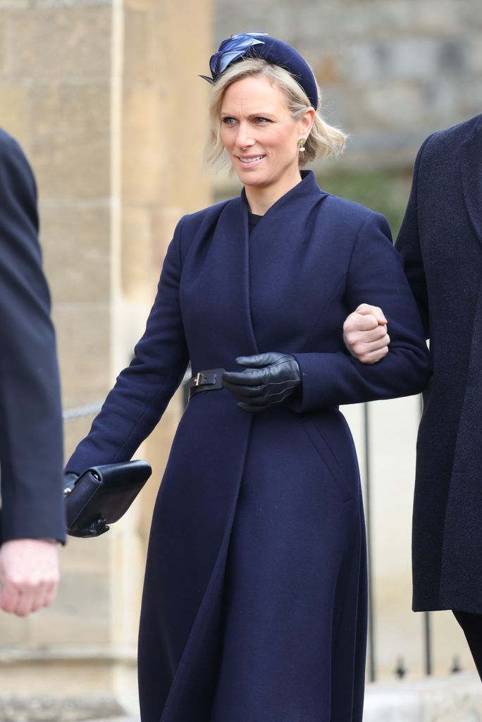 Zara in navy coat dress with a bold headband and leather gloves