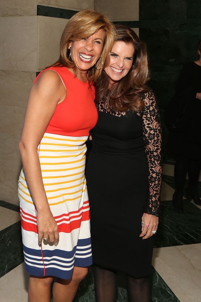 HodaKotb and Maria Shriver wrap their arms around each other and pose for a picture