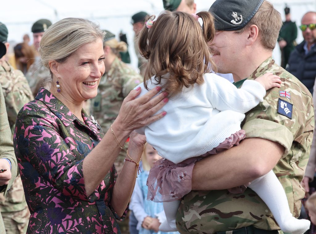 Duchess Sophie with pink nails talking to a child