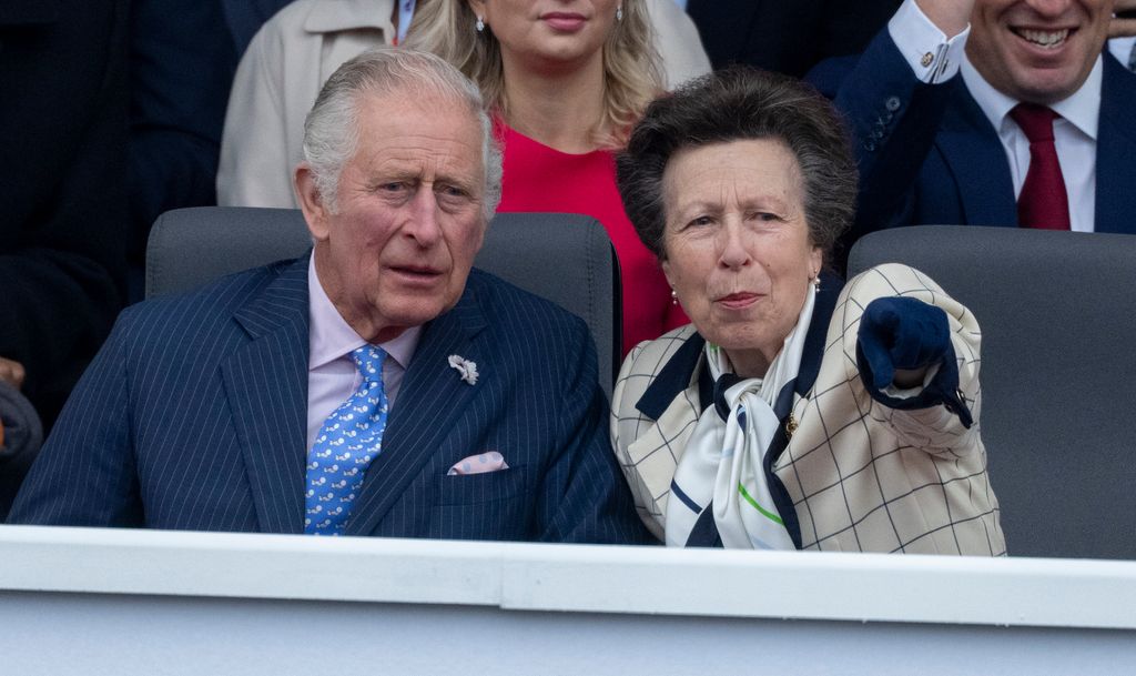 Princess Anne pointing something out to King Charles