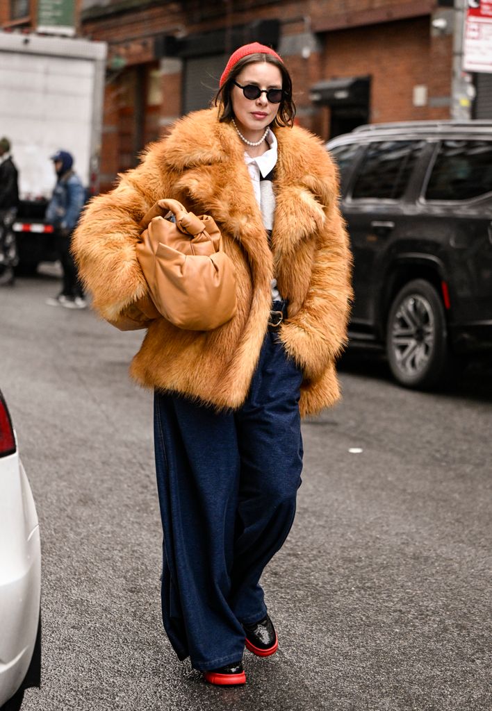 Marina Ingvarsson is seen with a tanned leather jacket, a large bag, blue and red boots and red boots out of Christian Siriano's show during NYFW F/W 2025 on February 6, 2025 in New York City. 