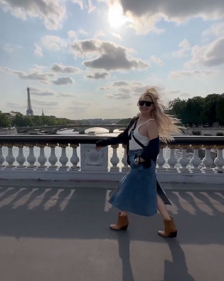 Kate walking across a bridge in Paris 