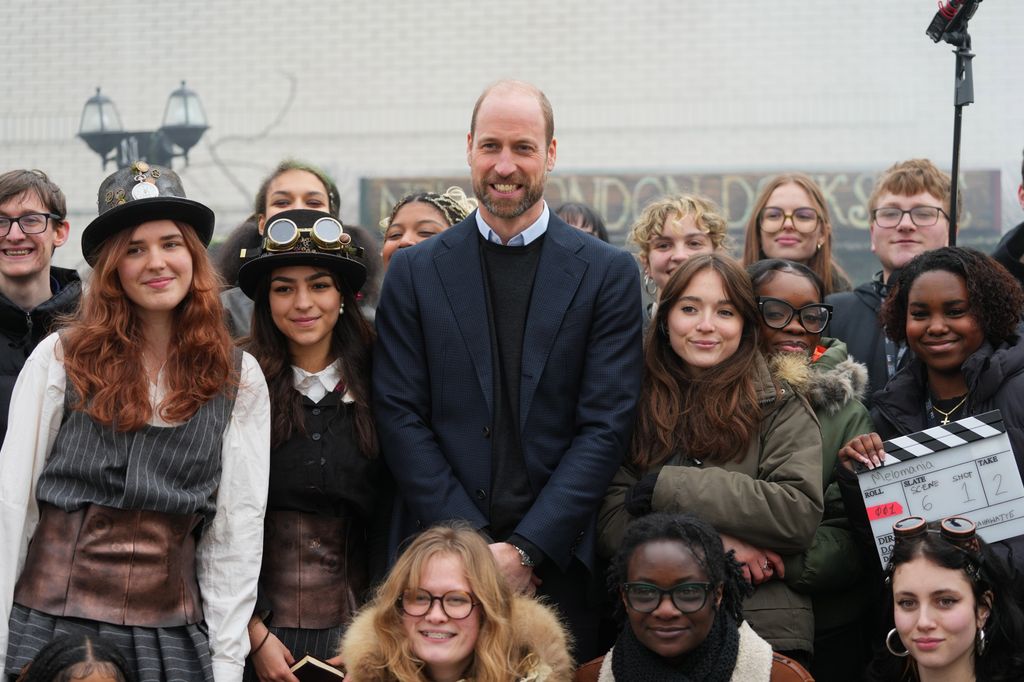 Prince William standing in a group of young people