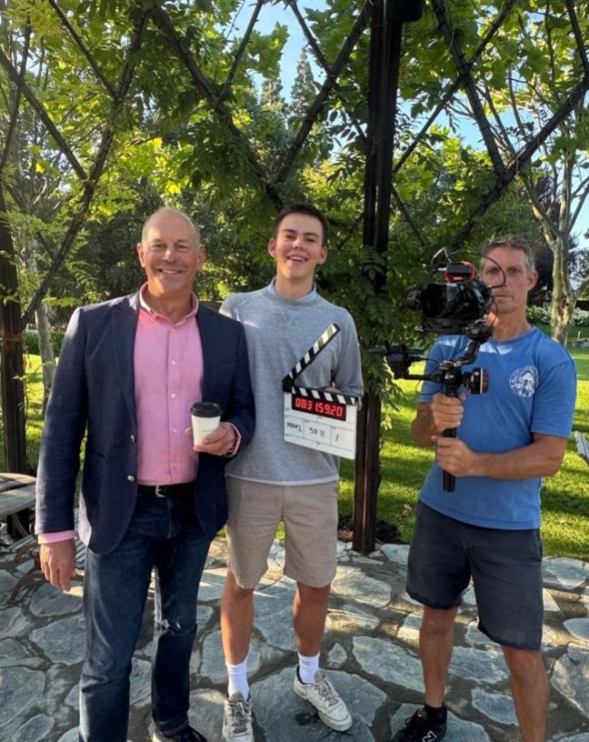 Phil Spencer, his son and a cameraman standing together